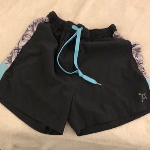 Two Pairs of Orange Theory Branded Shorts